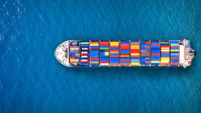 Aerial view of container cargo ship in sea.